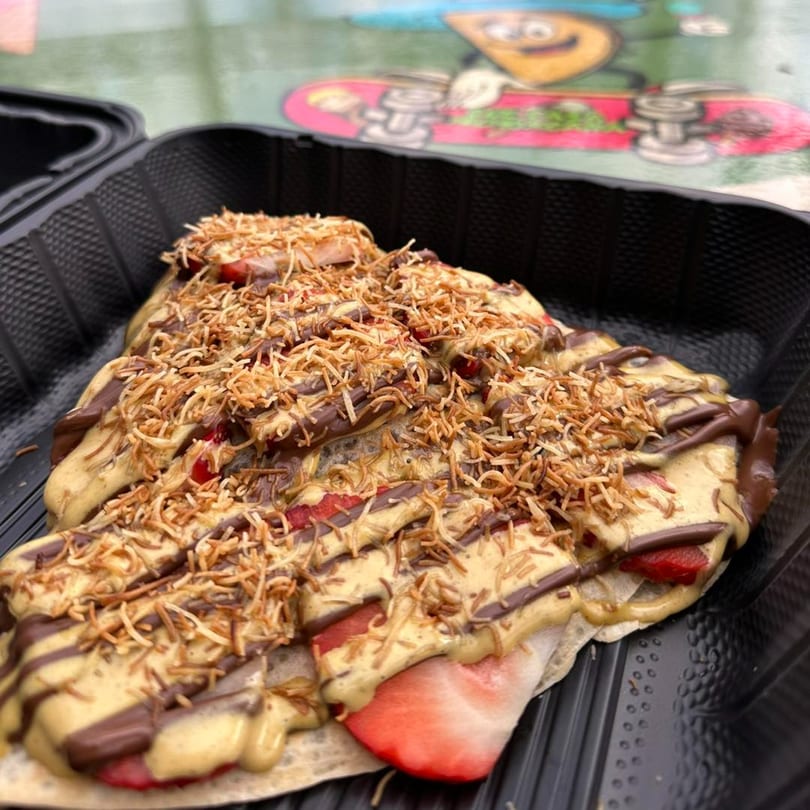 A Que Pasa Michoacana crepe with strawberries, chocolate, peanut butter, and toasted coconut flakes.
