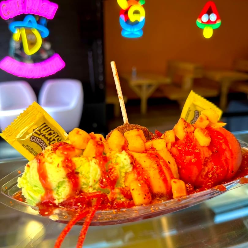 Que Pasa Michoacana's mango ice cream with chili, mango chunks, and Lucas Gusano candy.